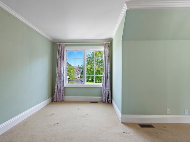 carpeted empty room featuring crown molding, visible vents, and baseboards