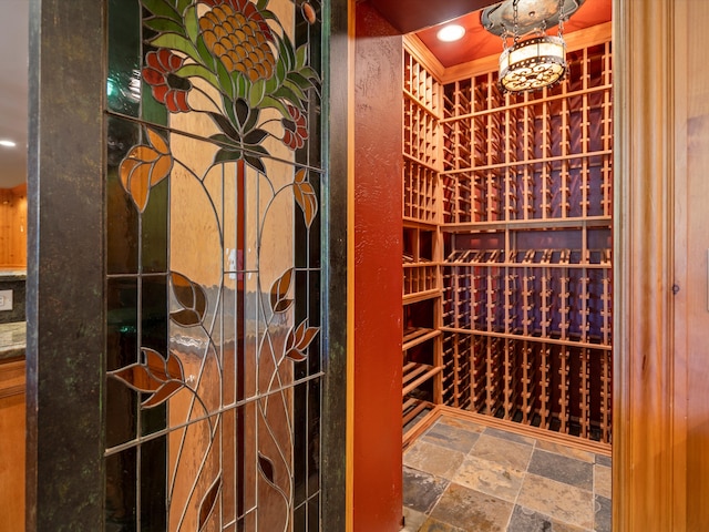 wine area featuring recessed lighting and stone tile flooring