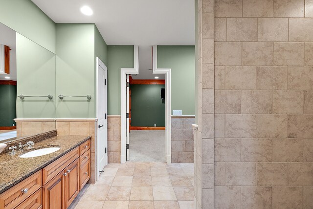bathroom with tile walls, recessed lighting, and vanity