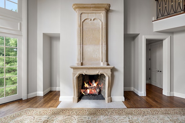 living area featuring a fireplace, plenty of natural light, and hardwood / wood-style floors