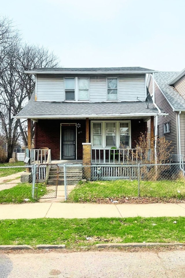 view of front of property with a porch, a fenced front yard, and brick siding