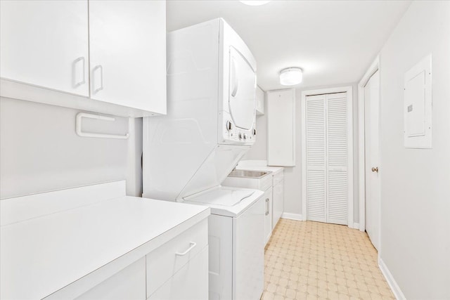 775 Deer Ct, Plymouth, MI 48170 - laundry area with light floors, electric panel, baseboards, cabinet space, and stacked washer / drying machine