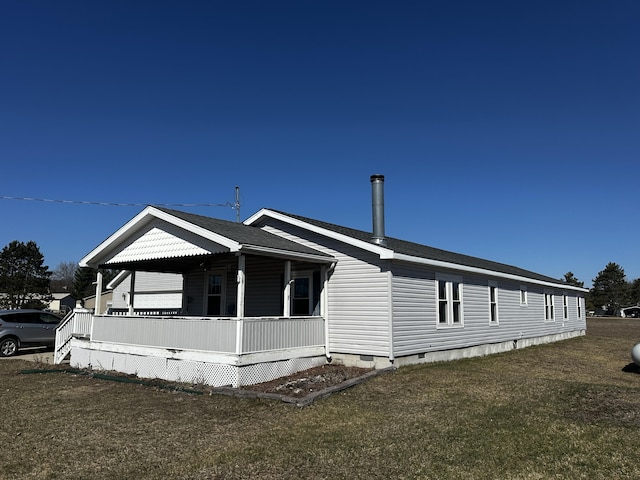 view of home's exterior with a lawn, a shingled roof, covered porch, and crawl space