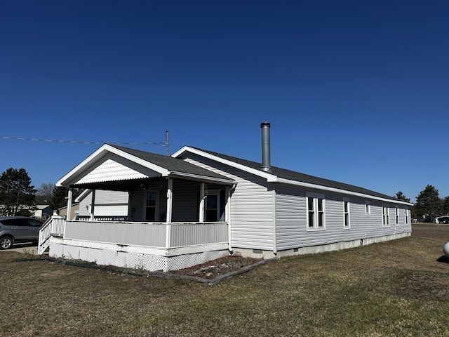 view of side of property with a yard, a porch, crawl space, and roof with shingles