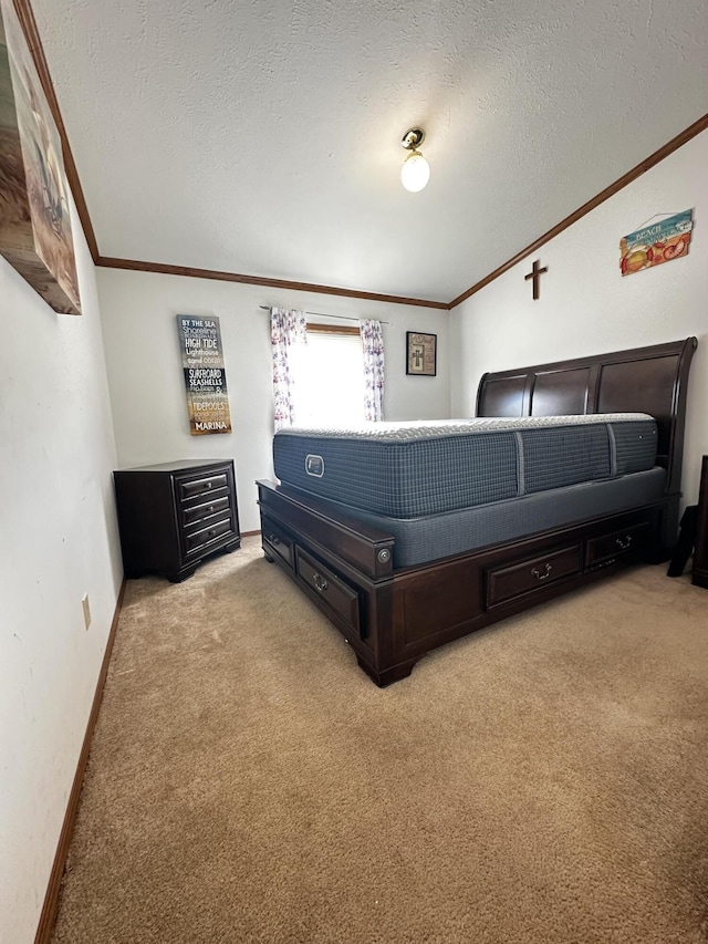carpeted bedroom with baseboards, ornamental molding, and a textured ceiling