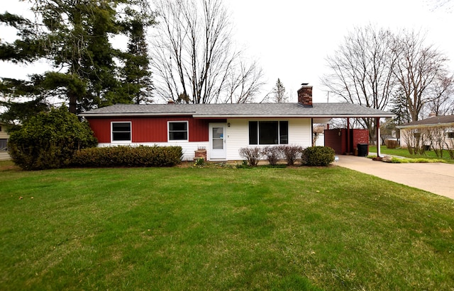 ranch-style house with a carport, a chimney, concrete driveway, and a front yard