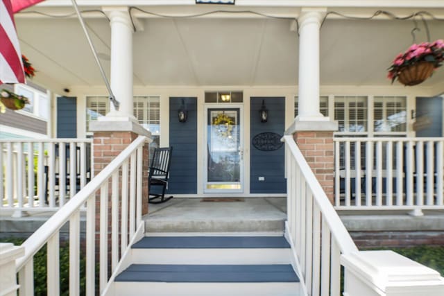 doorway to property featuring covered porch
