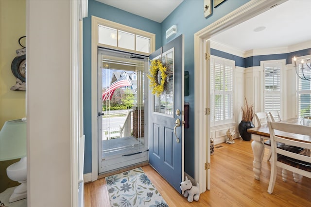 foyer with light wood-style floors, baseboards, and a healthy amount of sunlight