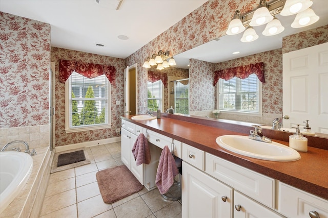 bathroom with double vanity, a shower stall, a sink, tile patterned floors, and wallpapered walls