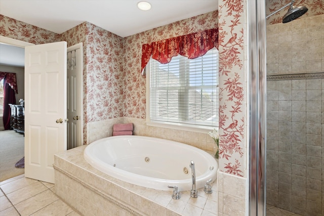 bathroom with wallpapered walls, a jetted tub, a healthy amount of sunlight, and a shower stall