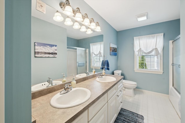 bathroom featuring a sink, baseboards, tile patterned flooring, and double vanity