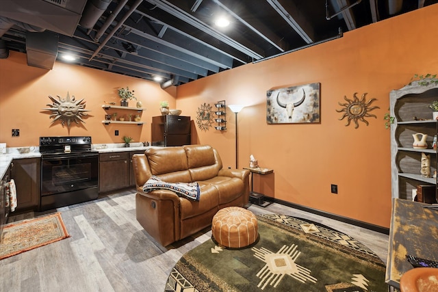 living area featuring light wood-style floors and baseboards