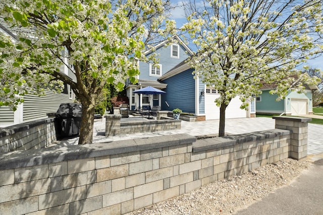 view of front of property with a patio area and a garage