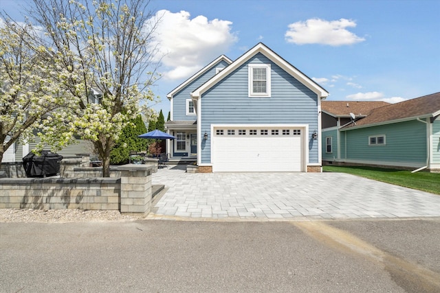 view of front of house with an attached garage and decorative driveway