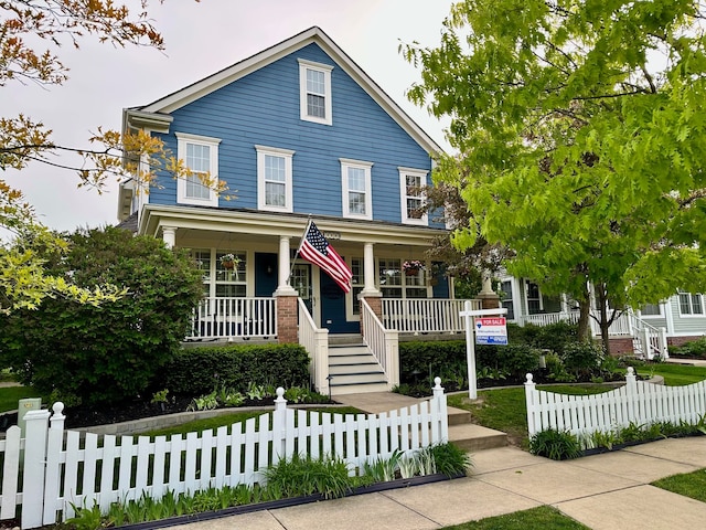 1728 Town Commons Dr, Howell, MI 48855 - view of front of property featuring covered porch, stairway, and a fenced front yard