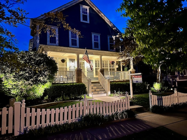 1728 Town Commons Dr, Howell, MI 48855 - view of front of house with covered porch, stairs, and a fenced front yard