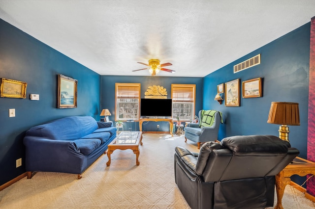 57480 72nd Ave, Hartford, MI 49057 - carpeted living area with visible vents, baseboards, a ceiling fan, and a textured ceiling