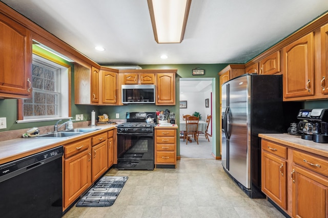 57480 72nd Ave, Hartford, MI 49057 - kitchen with a sink, light countertops, brown cabinets, black appliances, and recessed lighting