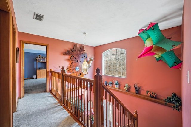 57480 72nd Ave, Hartford, MI 49057 - hallway featuring visible vents, an upstairs landing, and carpet