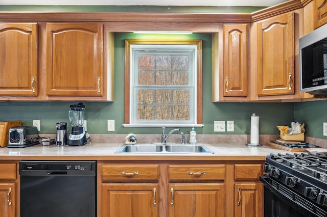 57480 72nd Ave, Hartford, MI 49057 - kitchen featuring light countertops, brown cabinets, a sink, and black appliances