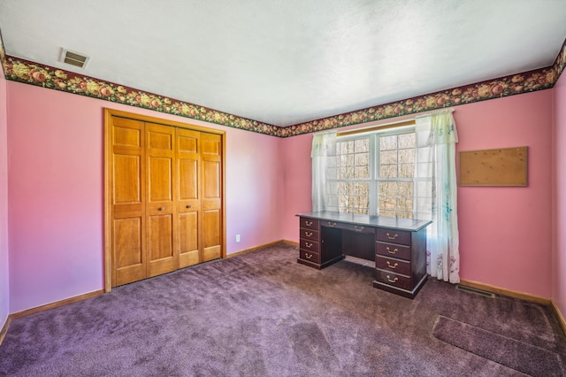 57480 72nd Ave, Hartford, MI 49057 - unfurnished bedroom with dark carpet, a closet, baseboards, and visible vents