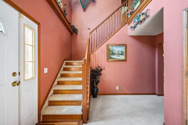 57480 72nd Ave, Hartford, MI 49057 - staircase with baseboards, carpet flooring, and a towering ceiling
