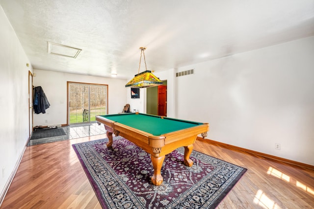 57480 72nd Ave, Hartford, MI 49057 - rec room with visible vents, baseboards, attic access, and light wood-style flooring