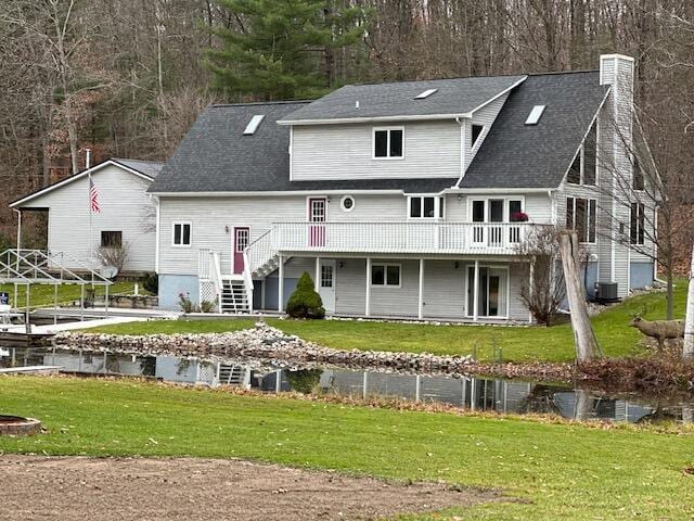 5095 Bliss Ln, Newaygo, MI 49337 - back of property with stairway, a chimney, and a lawn