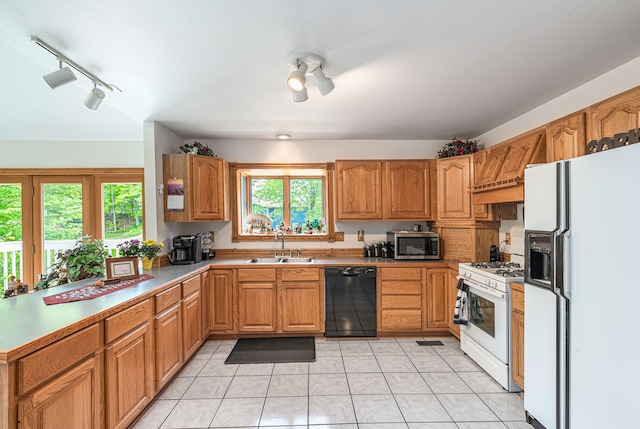 5095 Bliss Ln, Newaygo, MI 49337 - kitchen with rail lighting, white appliances, light tile patterned floors, premium range hood, and a sink