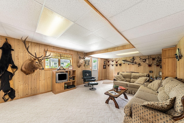 5095 Bliss Ln, Newaygo, MI 49337 - living room featuring wood walls, a drop ceiling, and carpet floors