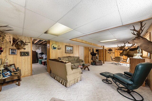 5095 Bliss Ln, Newaygo, MI 49337 - carpeted living room featuring wooden walls and a paneled ceiling