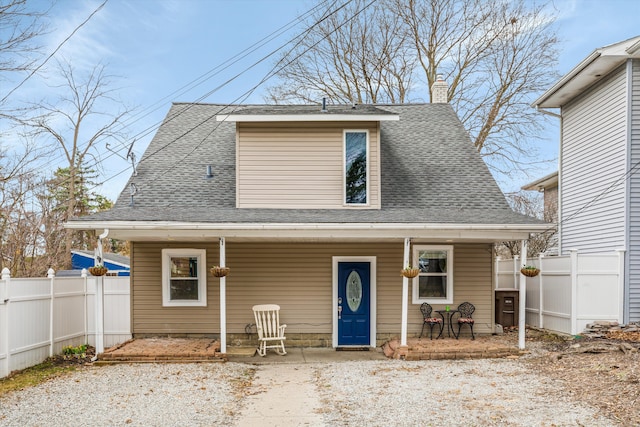 bungalow-style house featuring a chimney, a porch, fence, and roof with shingles