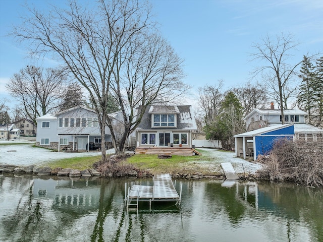 back of property featuring a water view