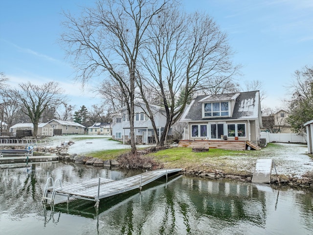 dock area featuring fence and a water view