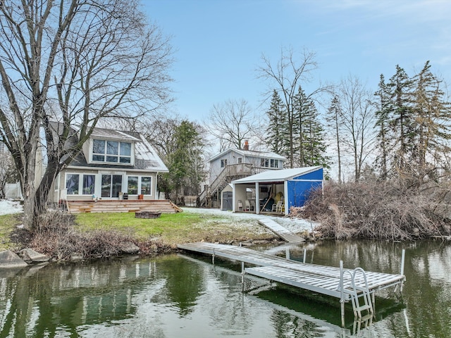 dock area featuring a water view and stairs