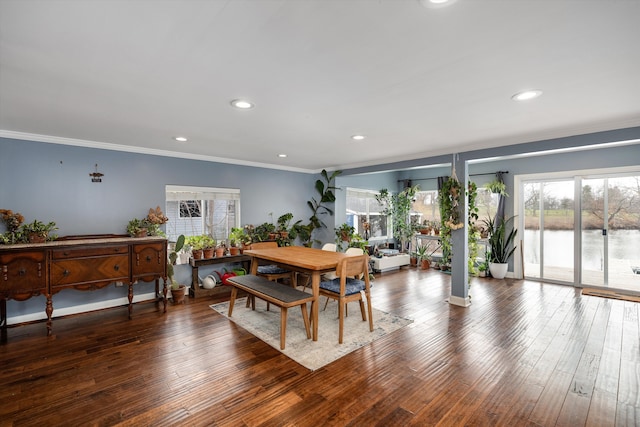 dining room with recessed lighting, hardwood / wood-style floors, ornamental molding, and a healthy amount of sunlight