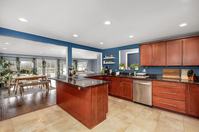 kitchen featuring dark stone counters, stainless steel dishwasher, open shelves, recessed lighting, and a sink