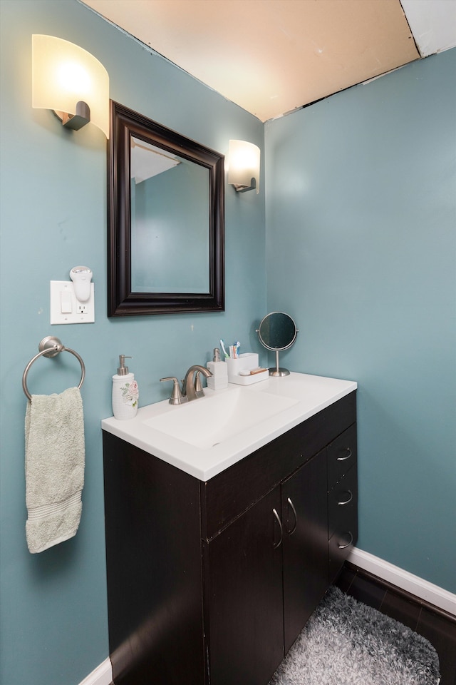 bathroom with tile patterned floors, vanity, and baseboards