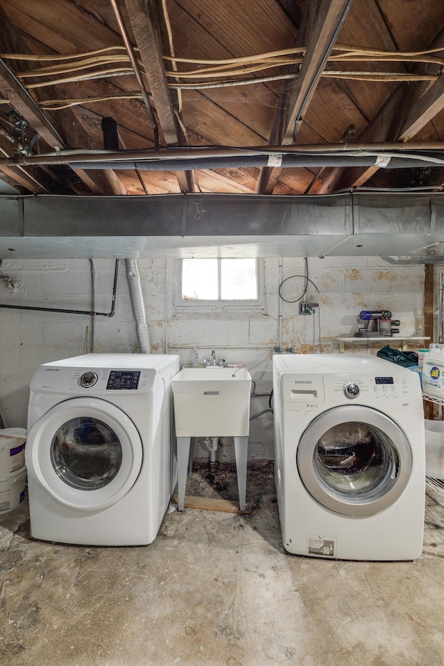 laundry room with separate washer and dryer, laundry area, and a sink
