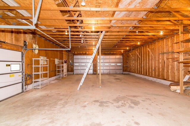 garage featuring wood walls