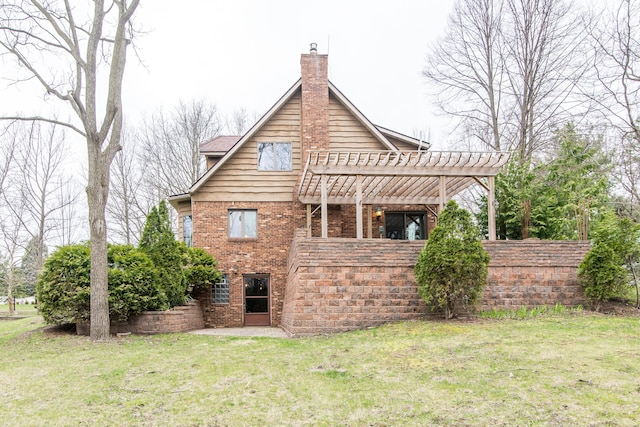 back of house featuring a pergola, a yard, a patio area, brick siding, and a chimney