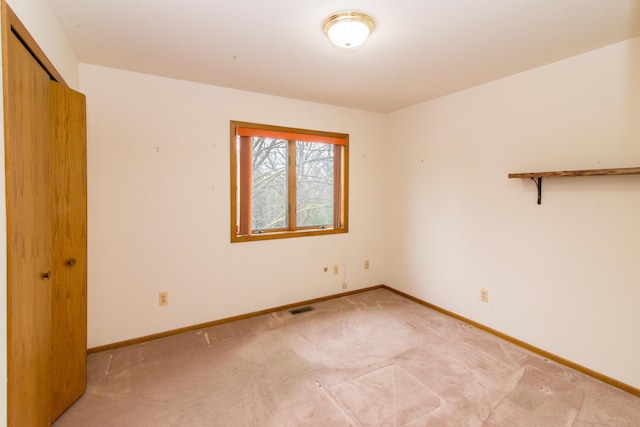 interior space featuring visible vents, baseboards, and light carpet