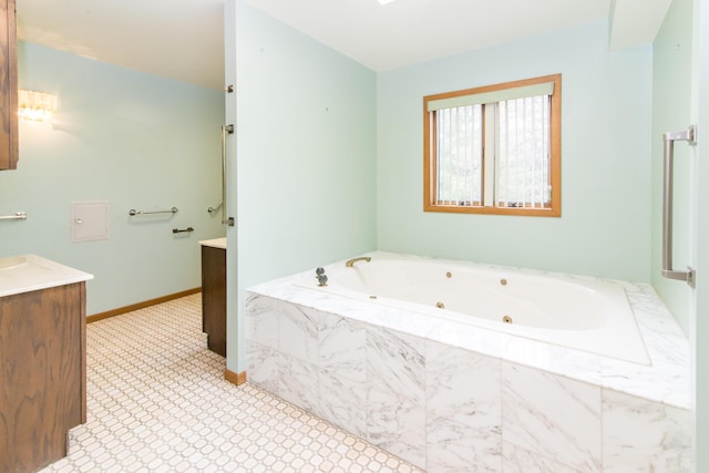full bathroom with a whirlpool tub, baseboards, vanity, and tile patterned flooring