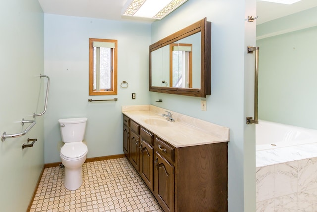 bathroom featuring baseboards, toilet, vanity, tile patterned floors, and a washtub