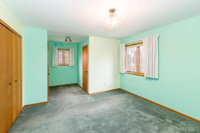 unfurnished bedroom featuring a closet, carpet flooring, and baseboards