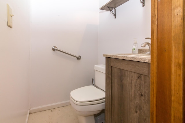 half bath featuring toilet, vanity, and baseboards