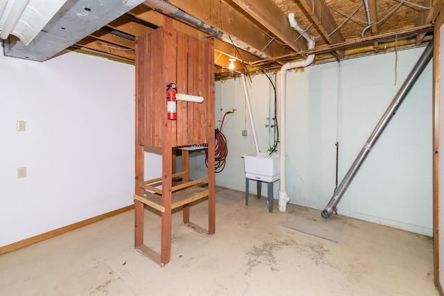 unfinished basement featuring a sink