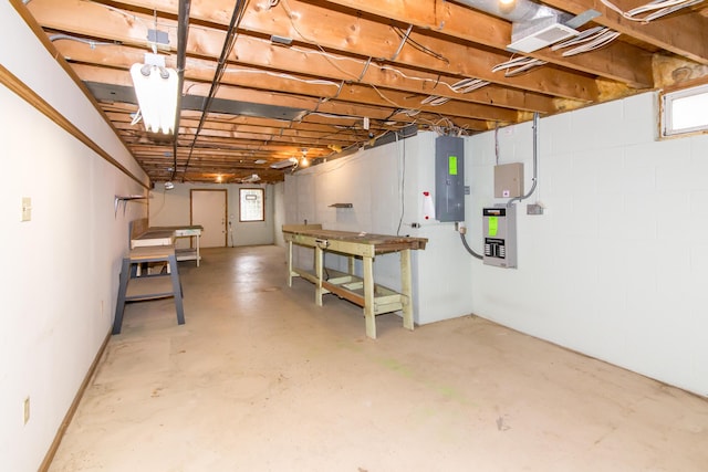below grade area with a healthy amount of sunlight, a workshop area, and electric panel