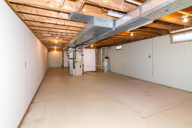 unfinished basement with water heater and heating unit
