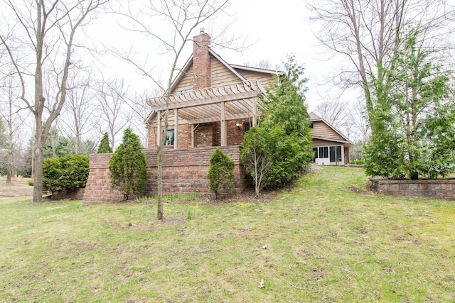 exterior space featuring a chimney, a sunroom, a lawn, and a pergola